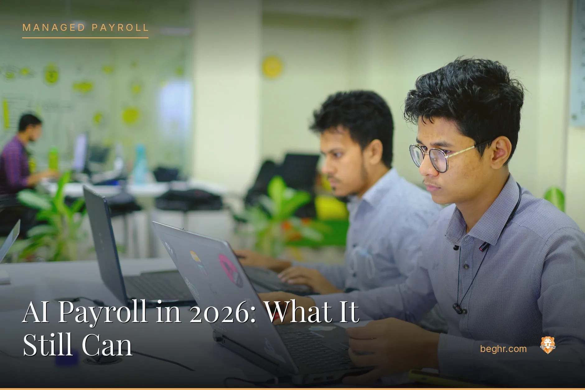 Professionals using HR software on laptops in a modern office