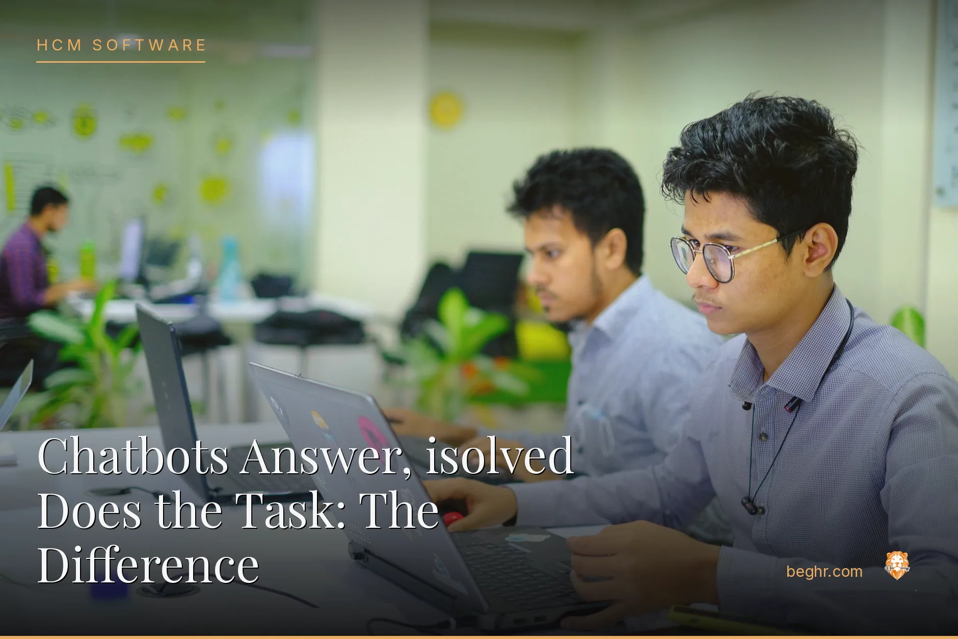 Professionals using HR software on laptops in a modern office