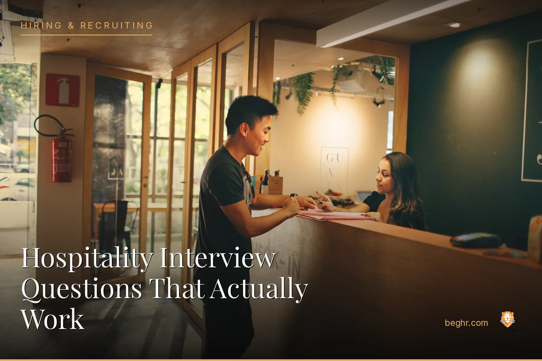 A hotel front desk and staff welcoming guests in a modern lobby