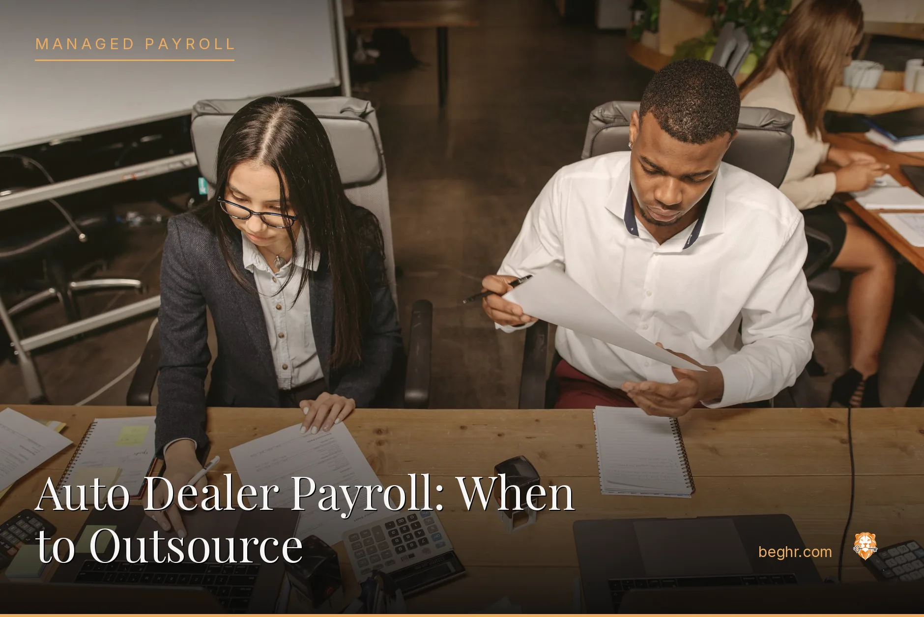 Business professionals reviewing payroll and HR documents in a bright modern office
