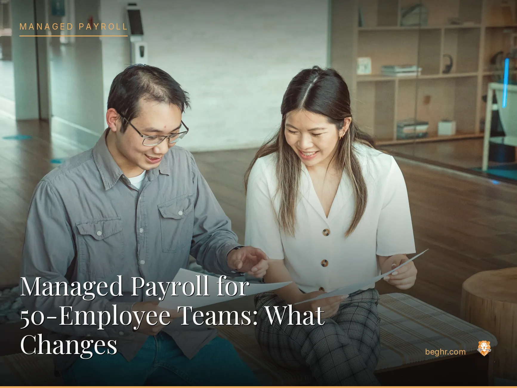 Business professionals reviewing payroll and HR documents in a bright modern office