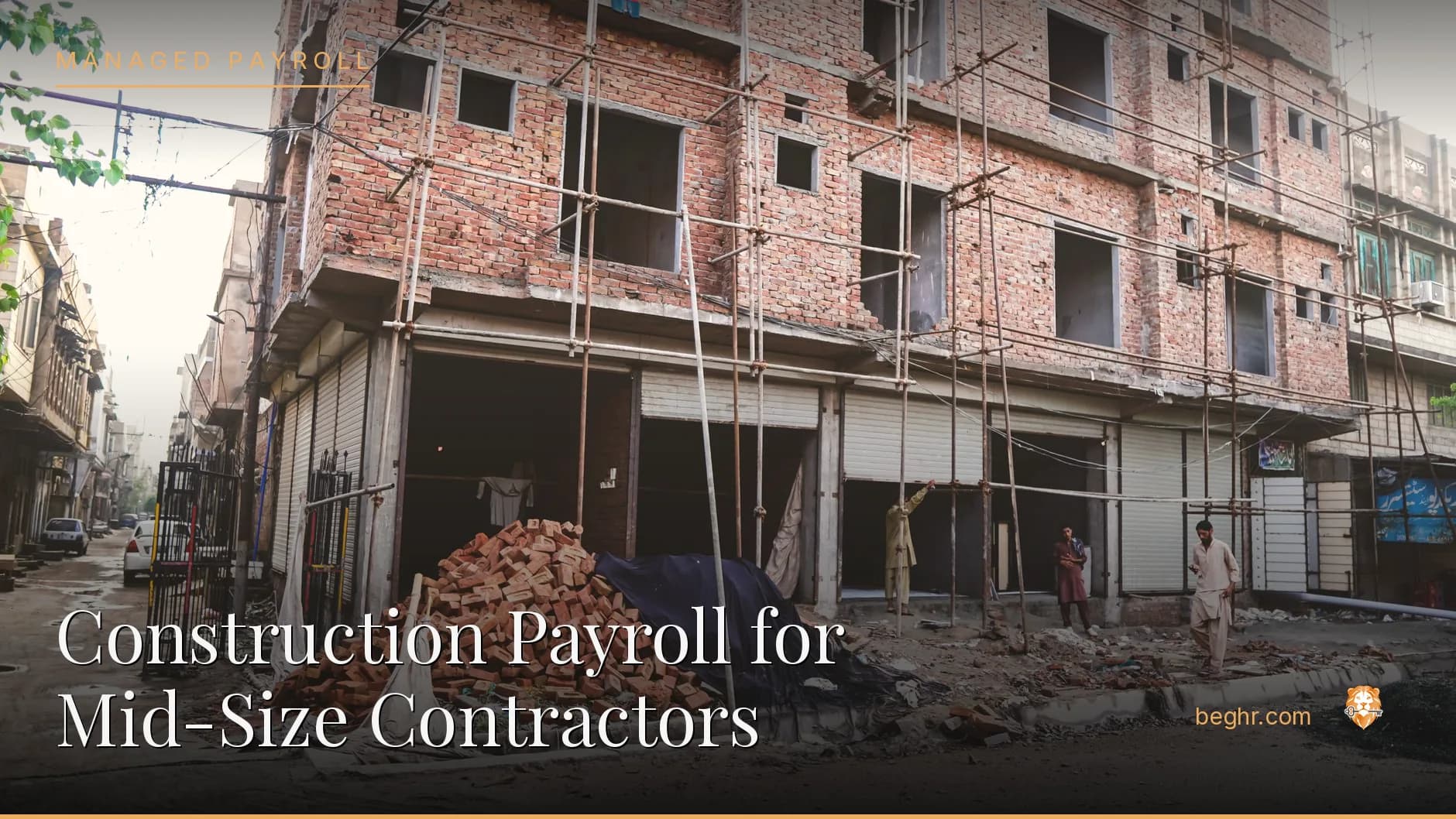 A real construction site, workers in hard hats and hi-vis vests reviewing plans