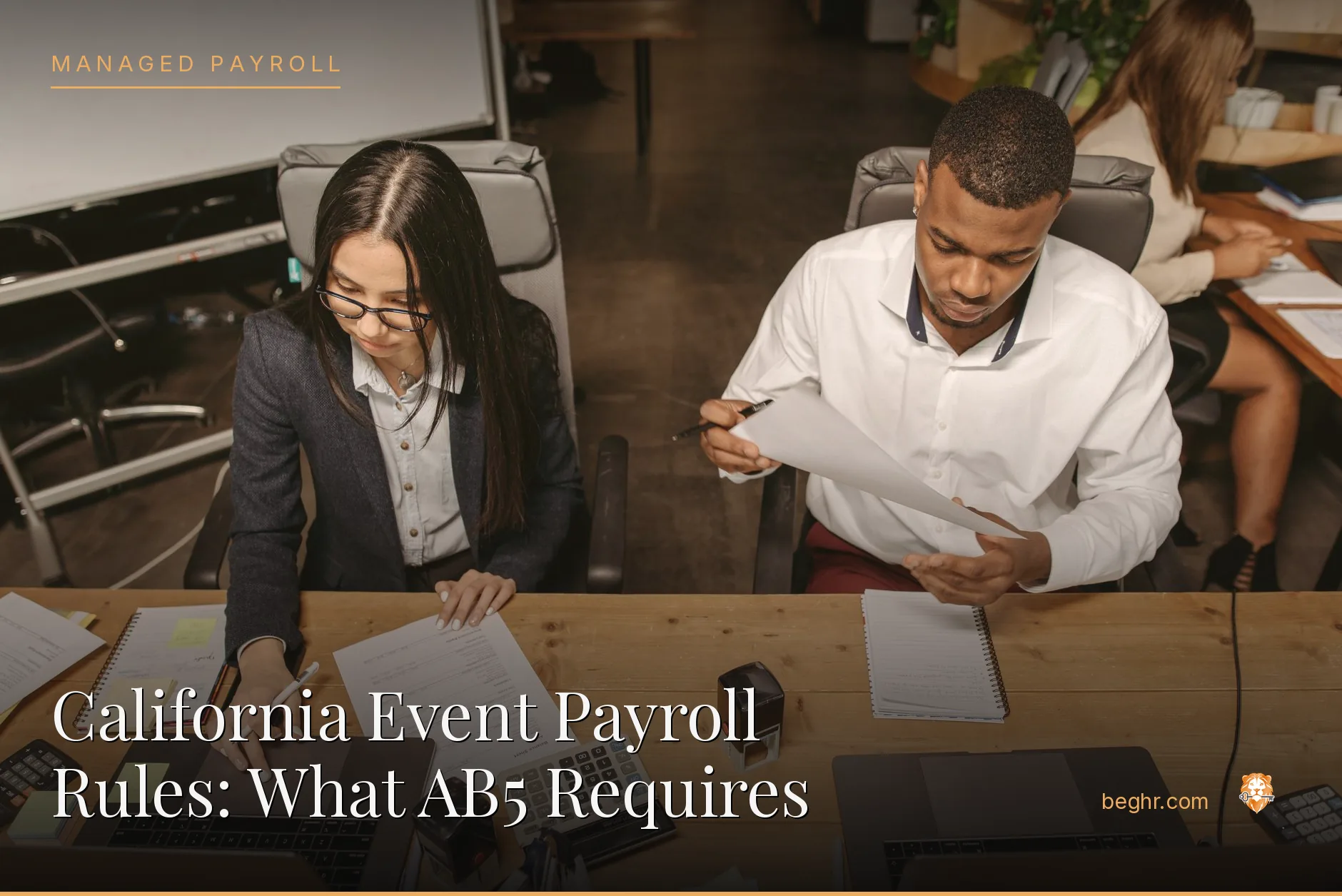 Business professionals reviewing payroll and HR documents in a bright modern office