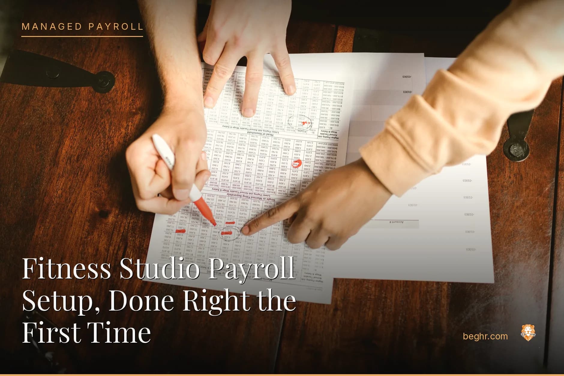 Business professionals reviewing payroll and HR documents in a bright modern office