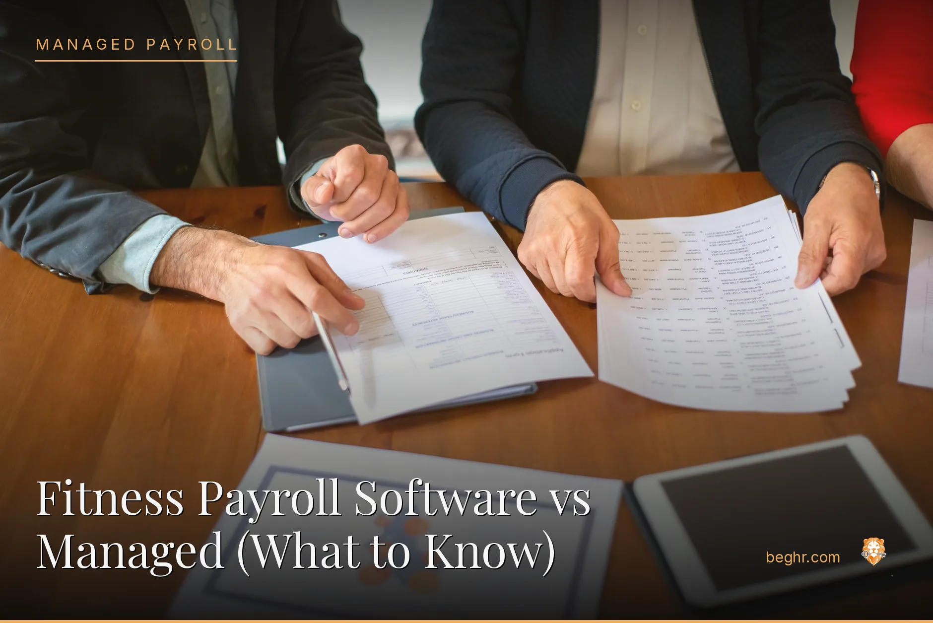 Business professionals reviewing payroll and HR documents in a bright modern office
