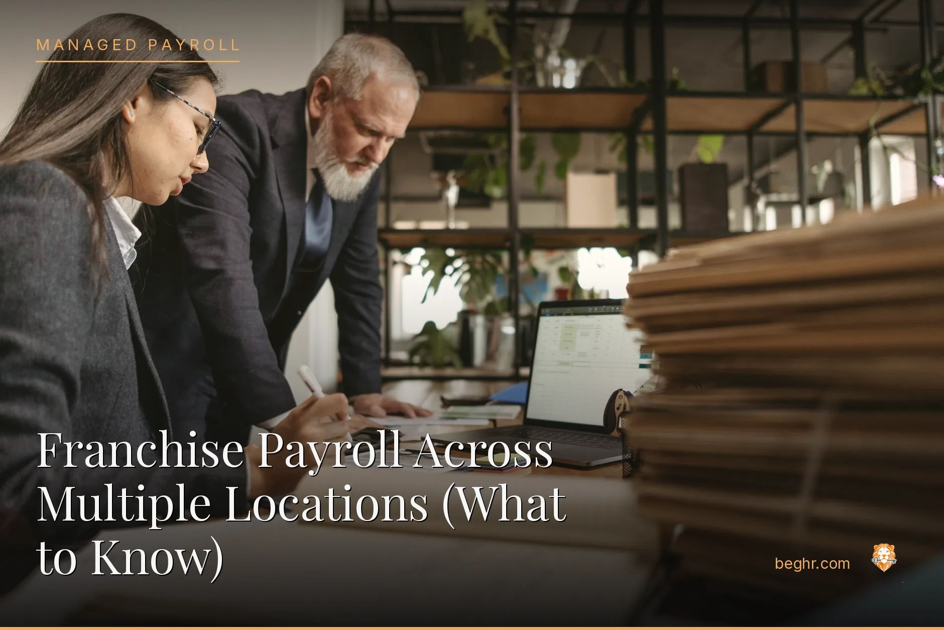 Business professionals reviewing payroll and HR documents in a bright modern office
