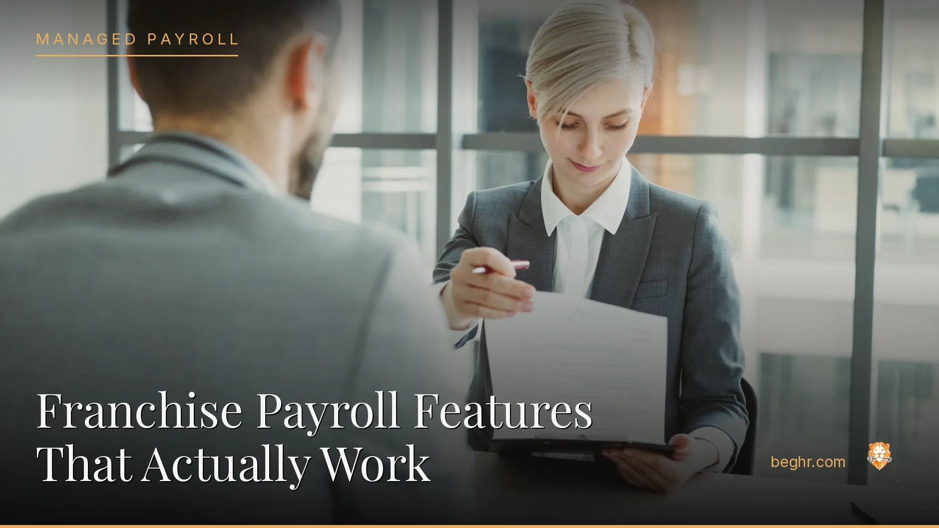 Business professionals reviewing payroll and HR documents in a bright modern office