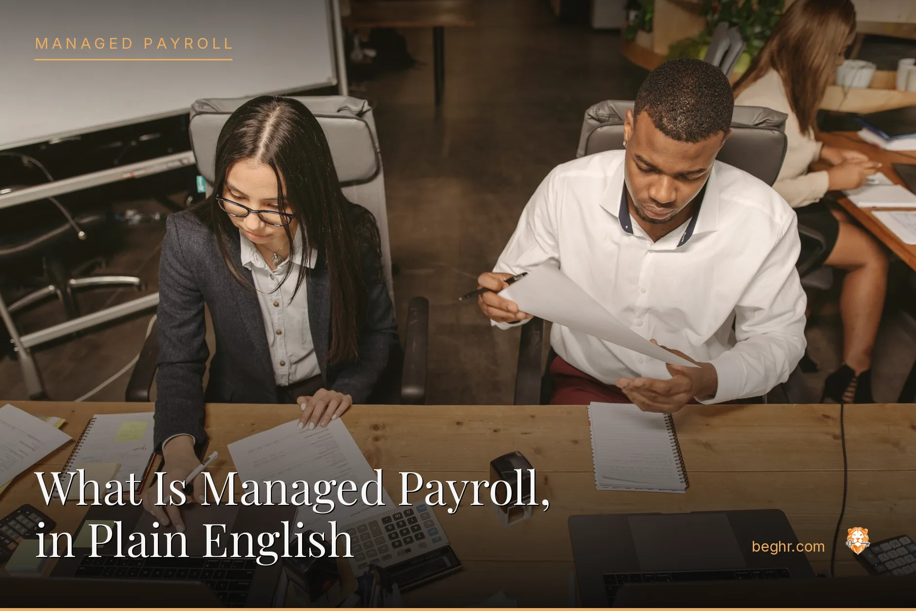 Business professionals reviewing payroll and HR documents in a bright modern office