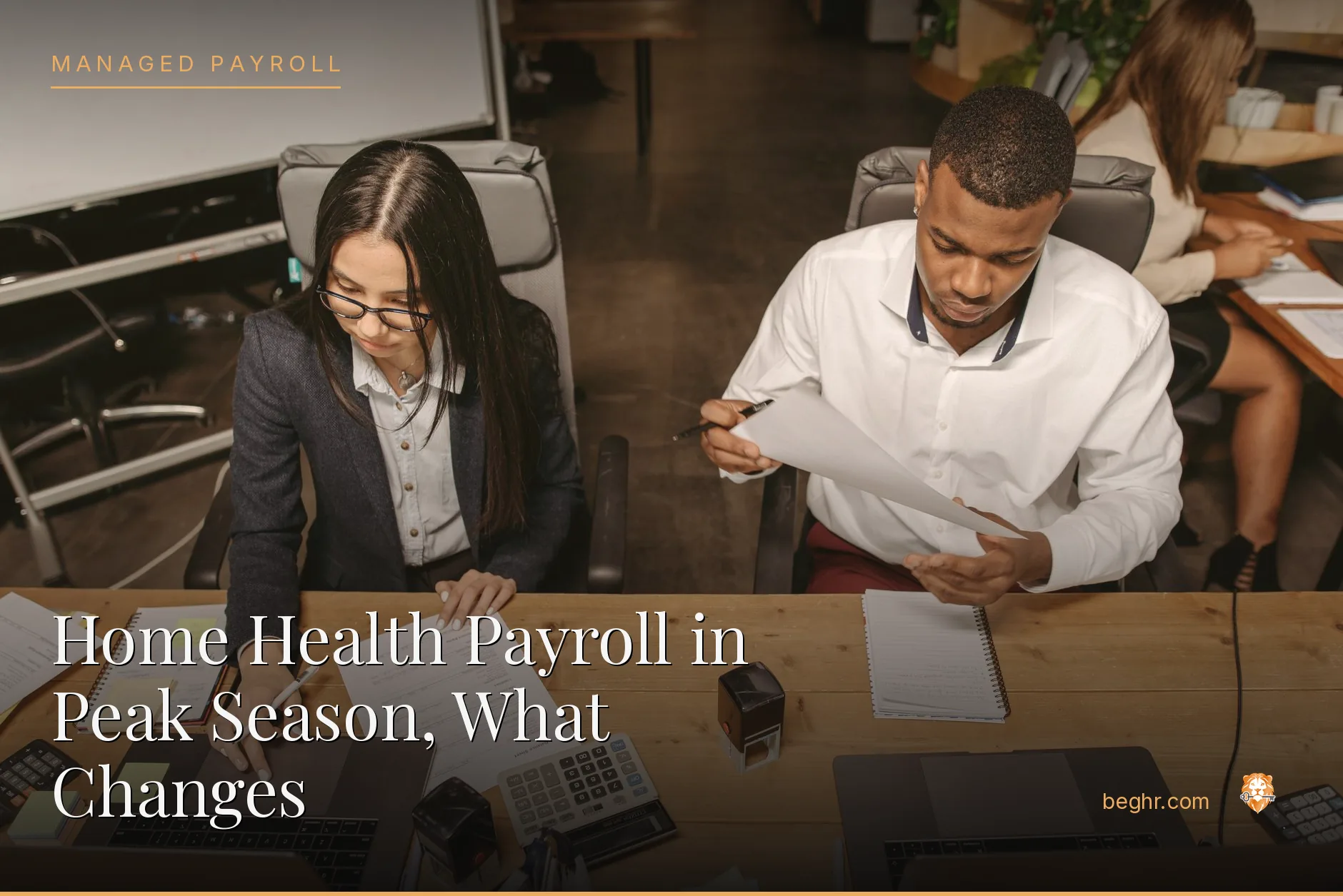Business professionals reviewing payroll and HR documents in a bright modern office