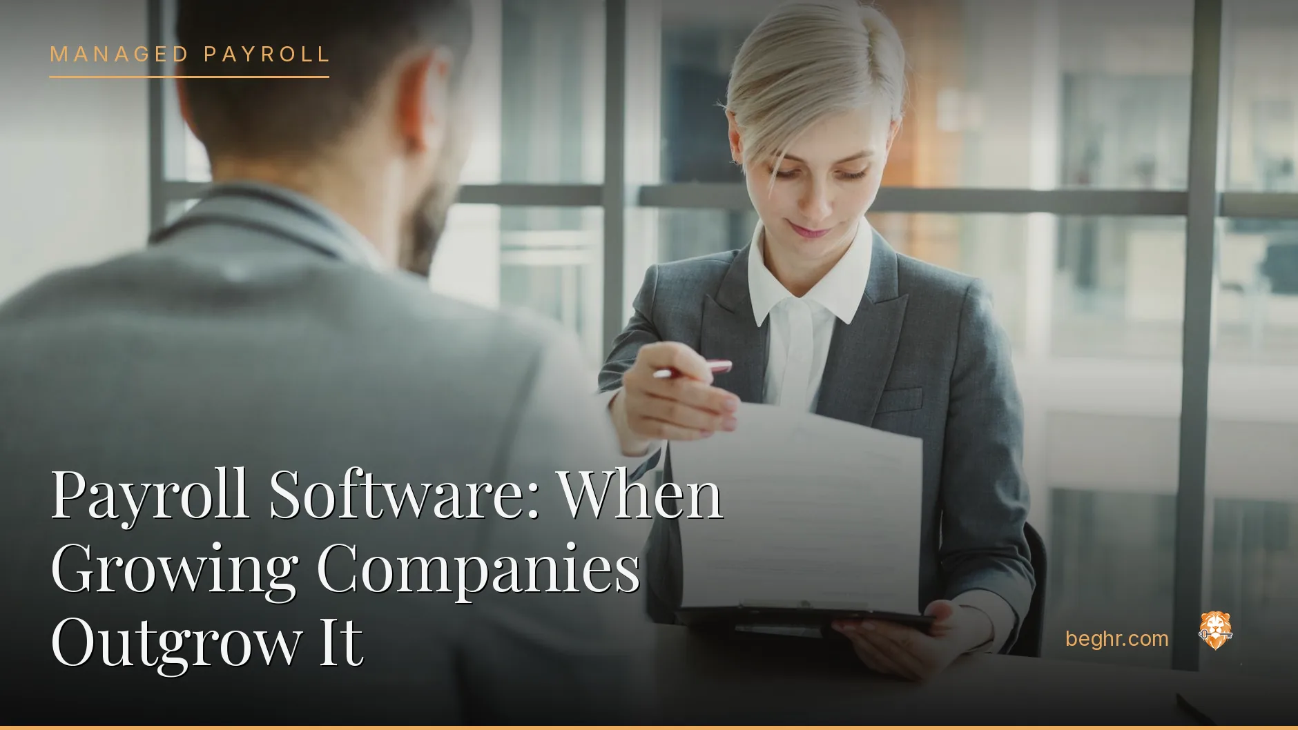 Business professionals reviewing payroll and HR documents in a bright modern office