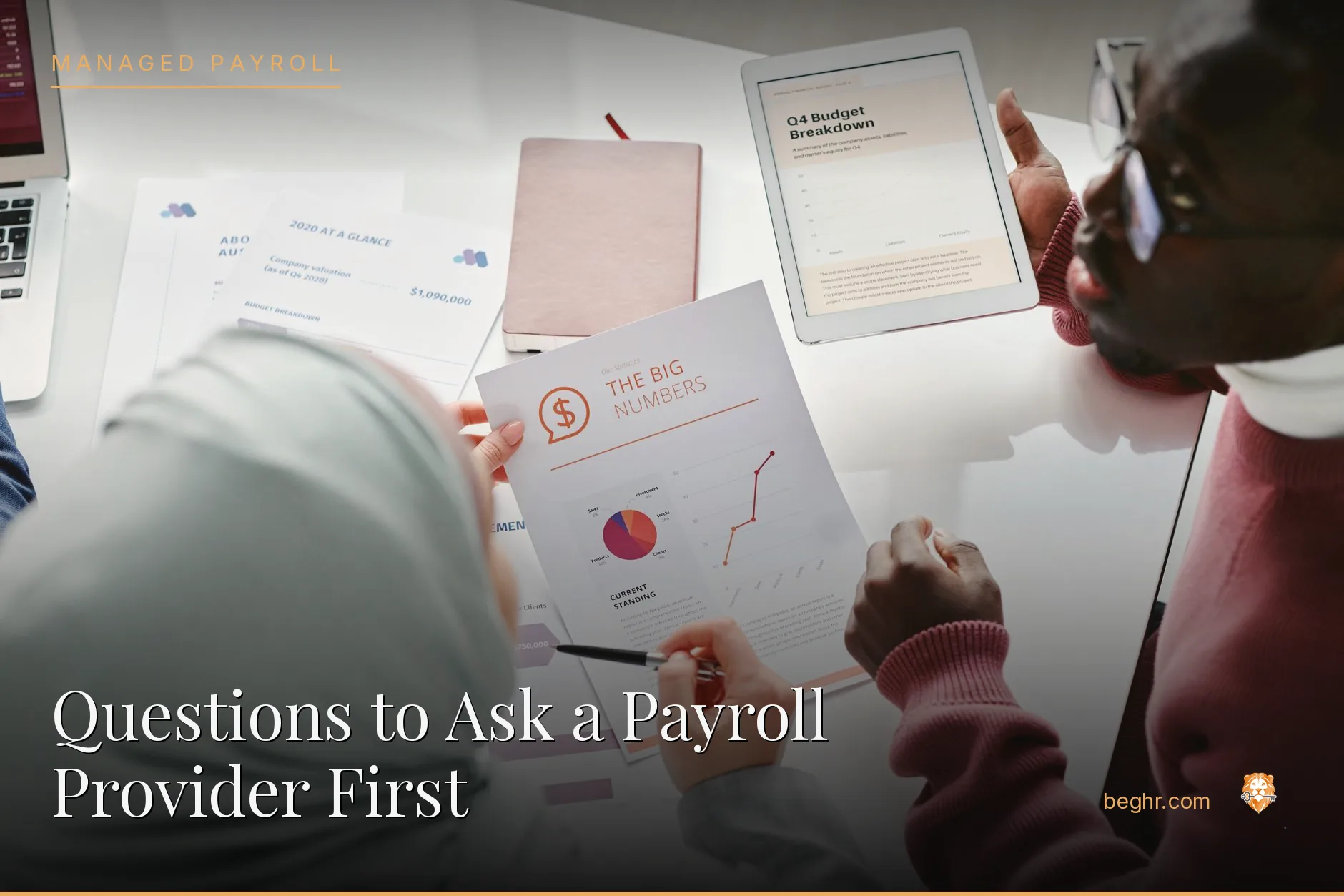 Business professionals reviewing payroll and HR documents in a bright modern office