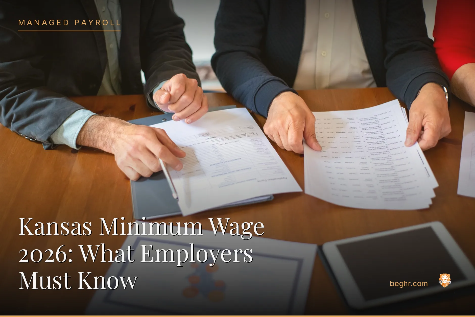 Business professionals reviewing payroll and HR documents in a bright modern office