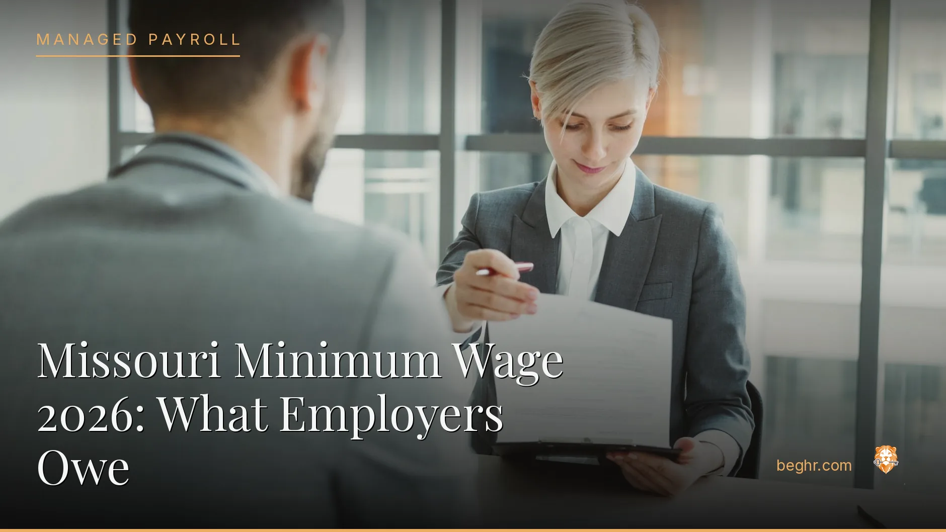 Business professionals reviewing payroll and HR documents in a bright modern office
