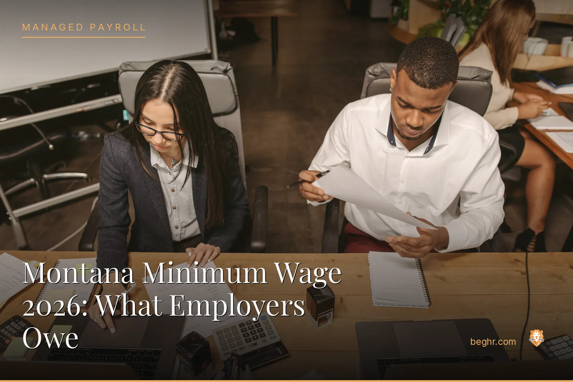 Business professionals reviewing payroll and HR documents in a bright modern office