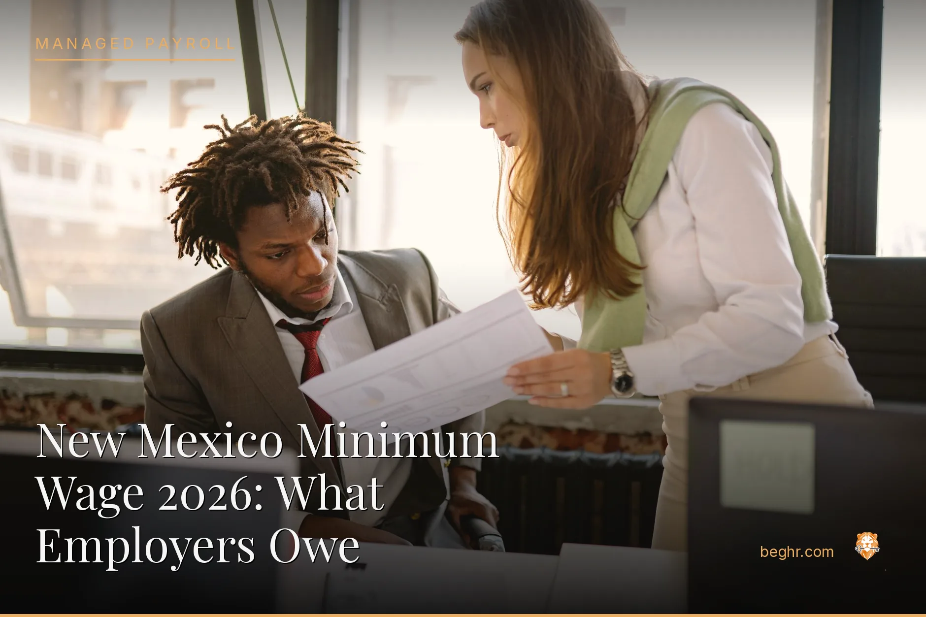 Business professionals reviewing payroll and HR documents in a bright modern office