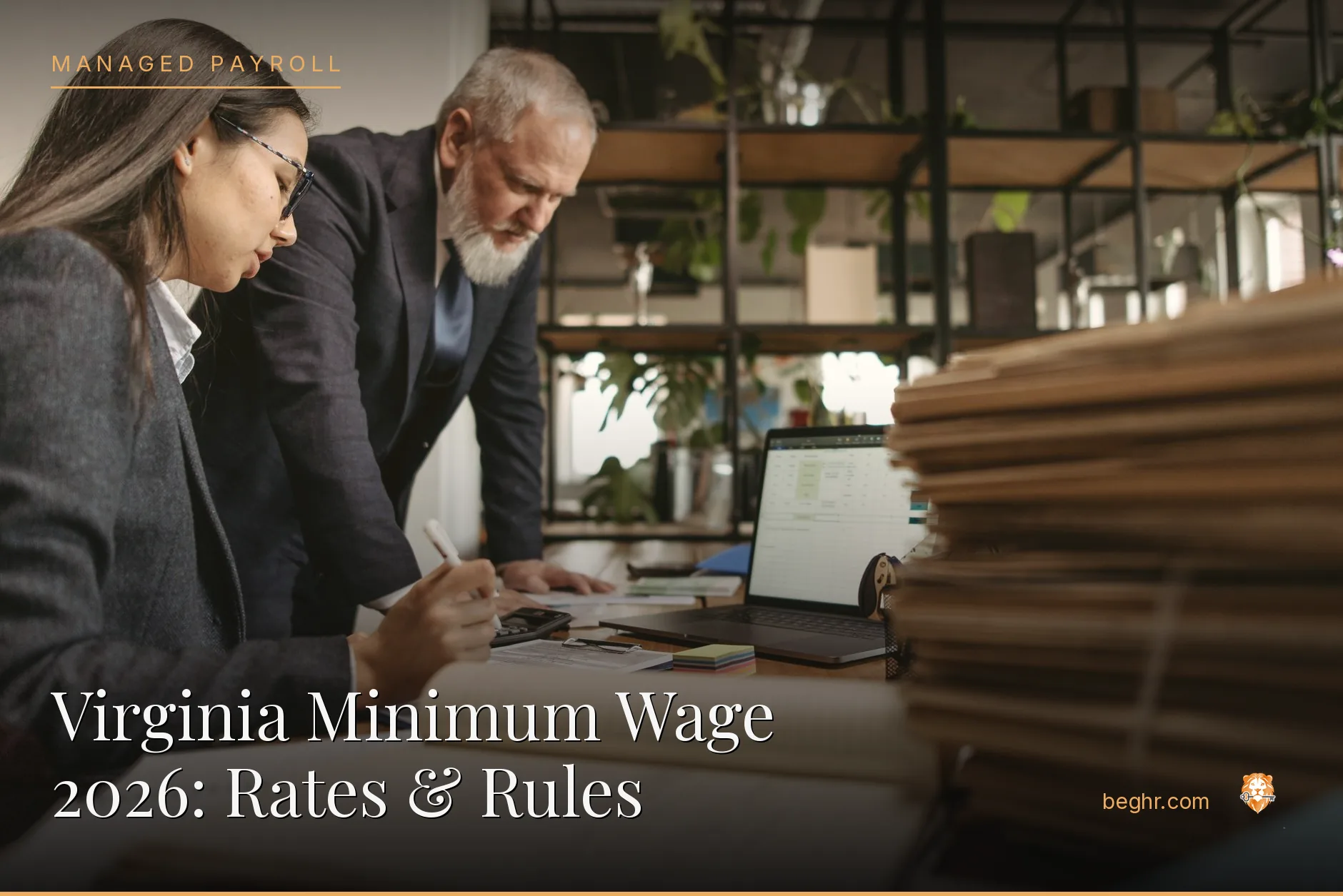 Business professionals reviewing payroll and HR documents in a bright modern office
