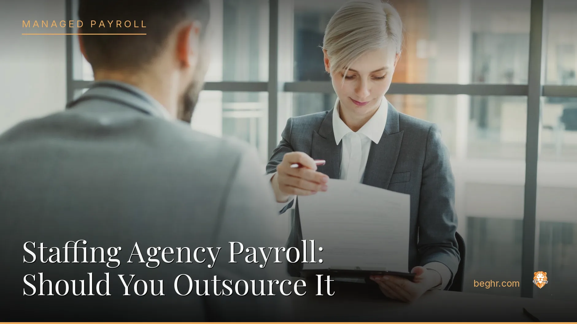 Business professionals reviewing payroll and HR documents in a bright modern office