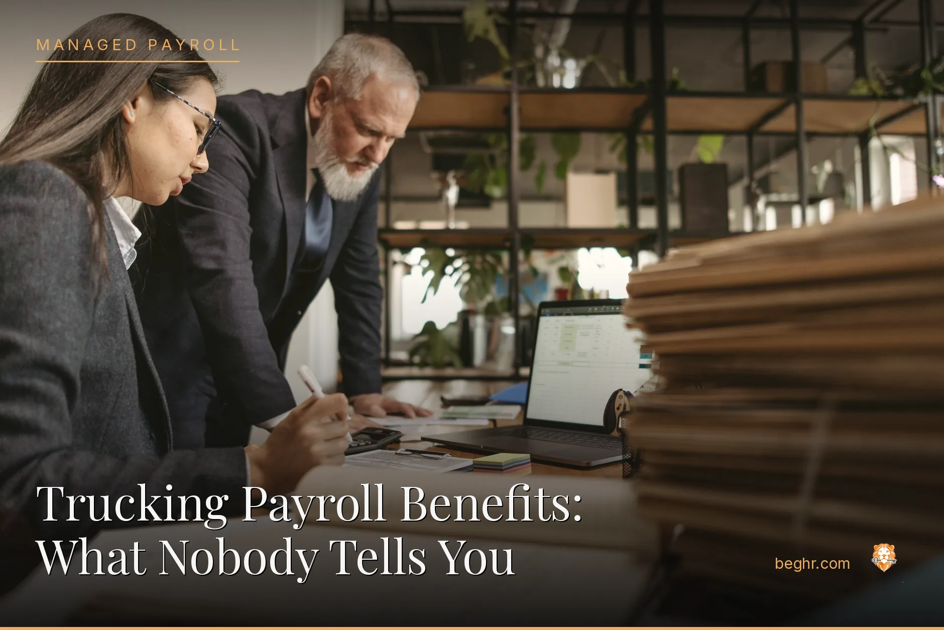Business professionals reviewing payroll and HR documents in a bright modern office