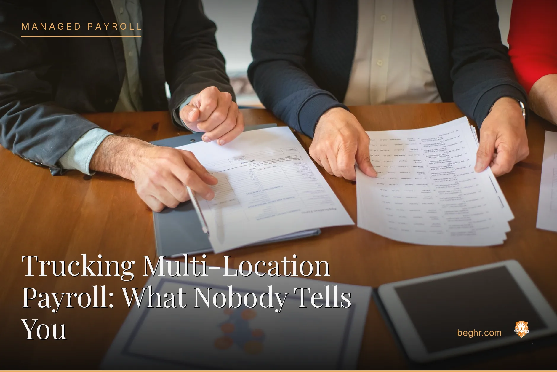 Business professionals reviewing payroll and HR documents in a bright modern office