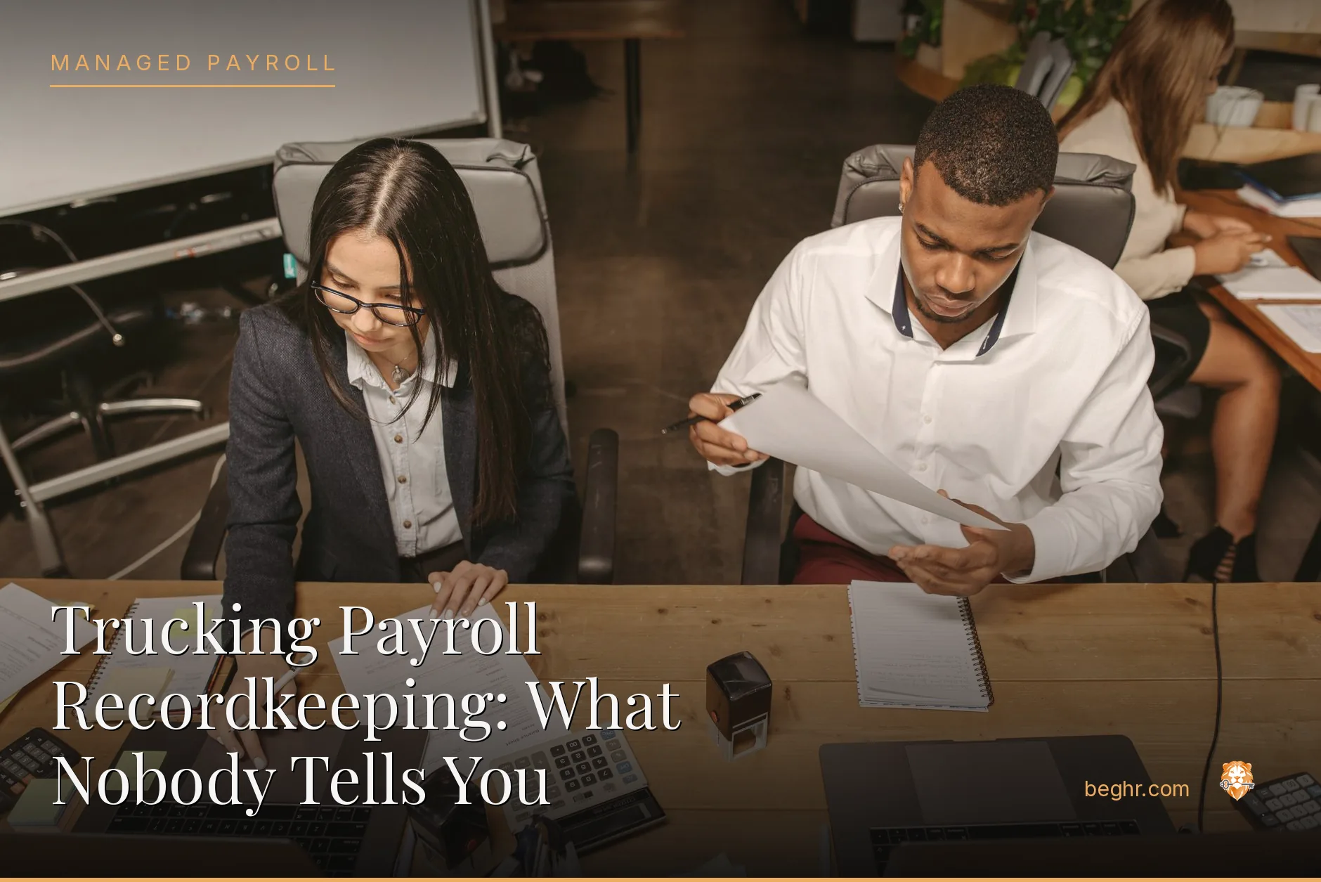 Business professionals reviewing payroll and HR documents in a bright modern office